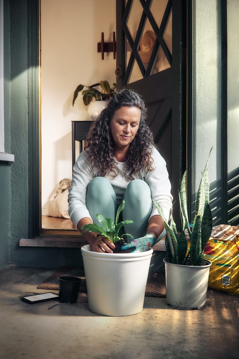Woman potting a plant on a porch